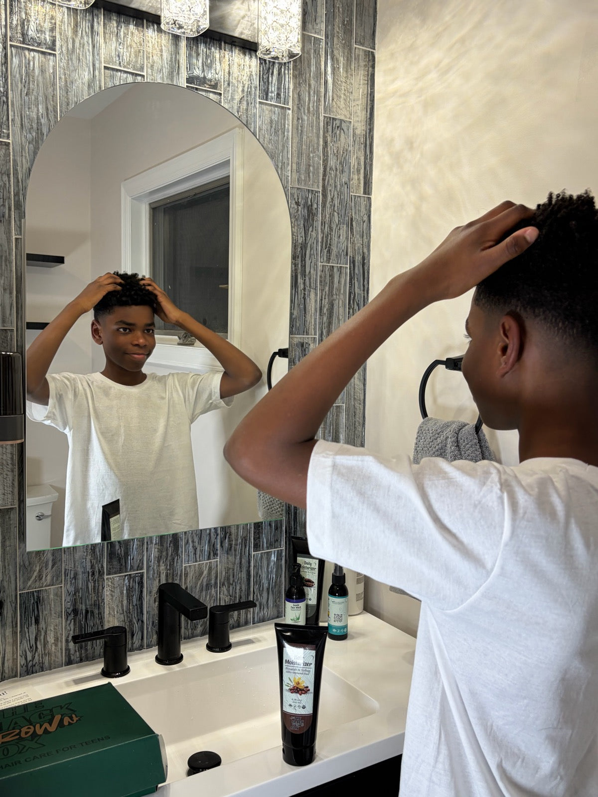 Load video: A simple grooming routine showing how teen boys can care for their hair and skin using The Black Crown Box while building confidence.